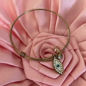 Gold toned evil eye charm bangle bracelet